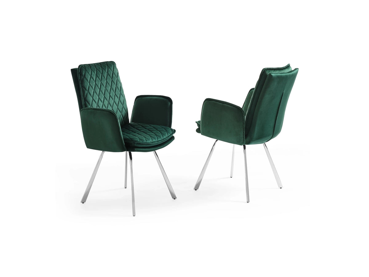 Two green velvet dining chairs with quilted diamond upholstery and sleek chrome legs stand against a white background.