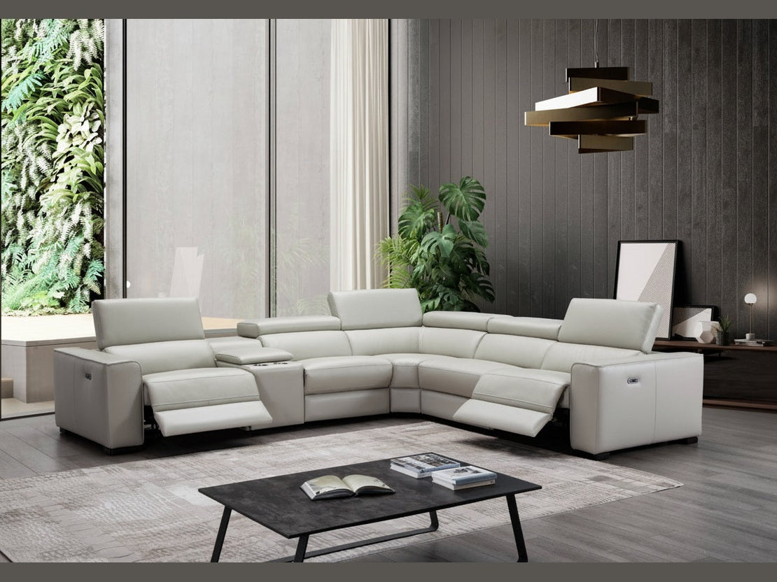 Modern living room with a sectional sofa, coffee table, and decorative items.