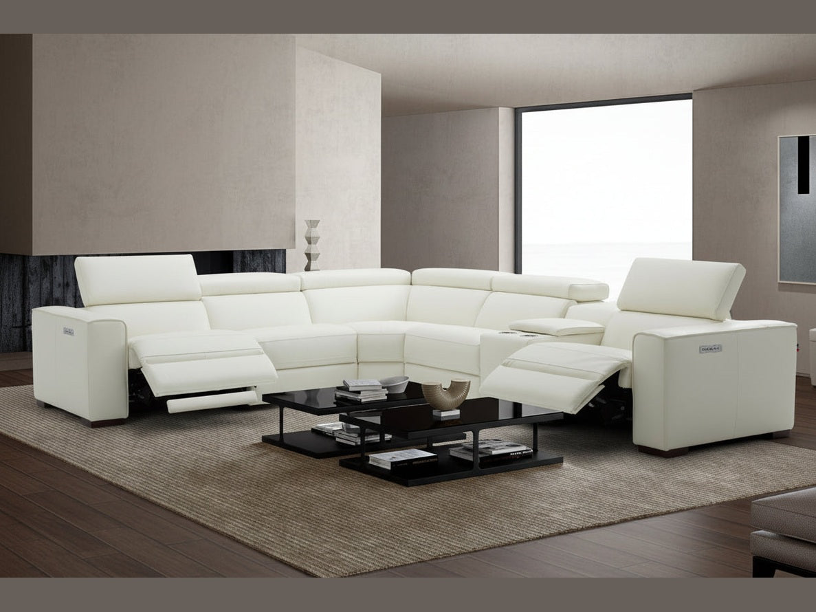 Modern white leather sectional sofa in a living room setting with a coffee table.