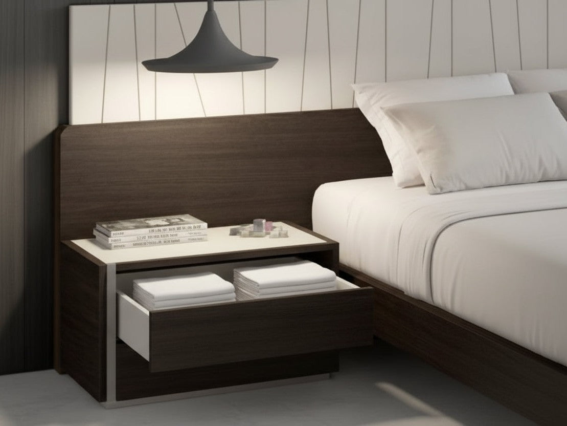 Porto bedroom setup with a bed and nightstand against a wooden headboard.