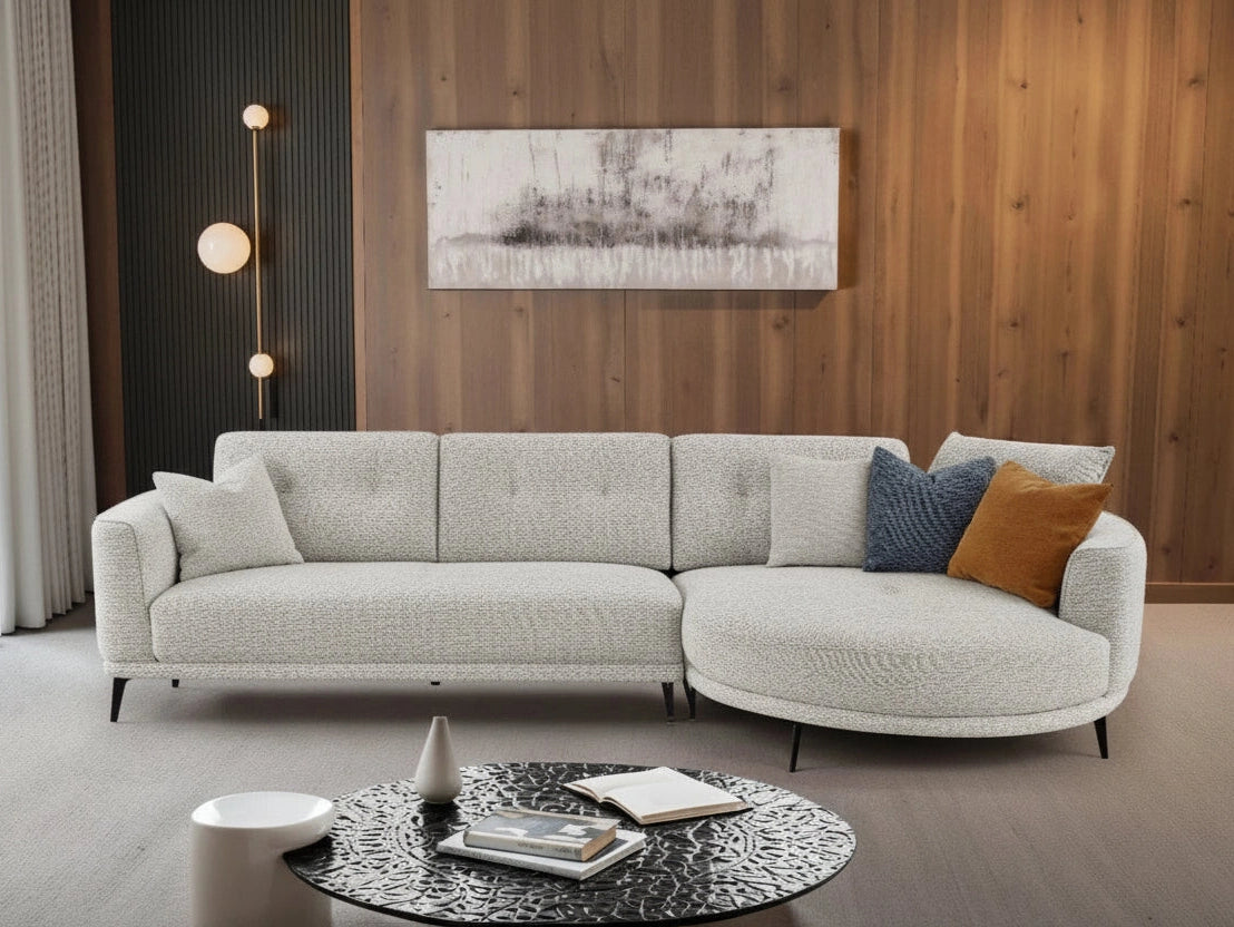 Rene modern gray sectional sofa, round coffee table, and decorative elements.
