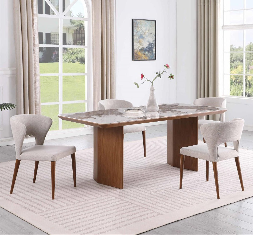 Dining room with a wooden table and chairs near large windows.