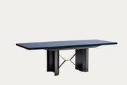 Oceanum modern extendable dining table with a dark blue top and black base on a white background.