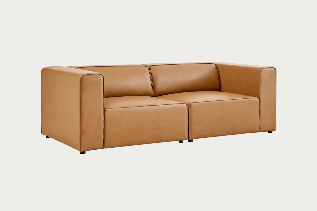 Tan leather sofa on a white background.