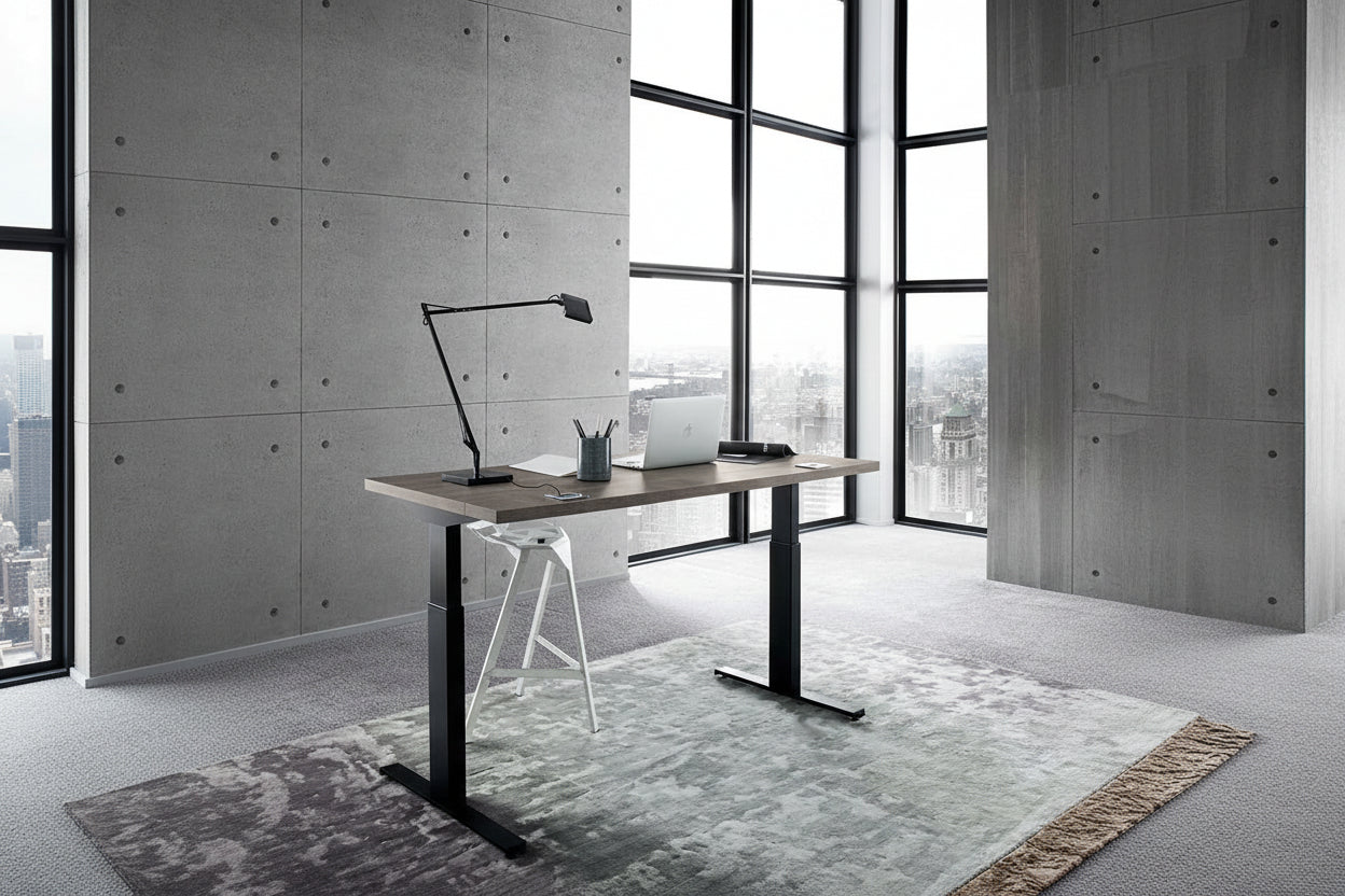 Tivoli office lift desk with a laptop, lamp, and pen holder in a room with large windows.