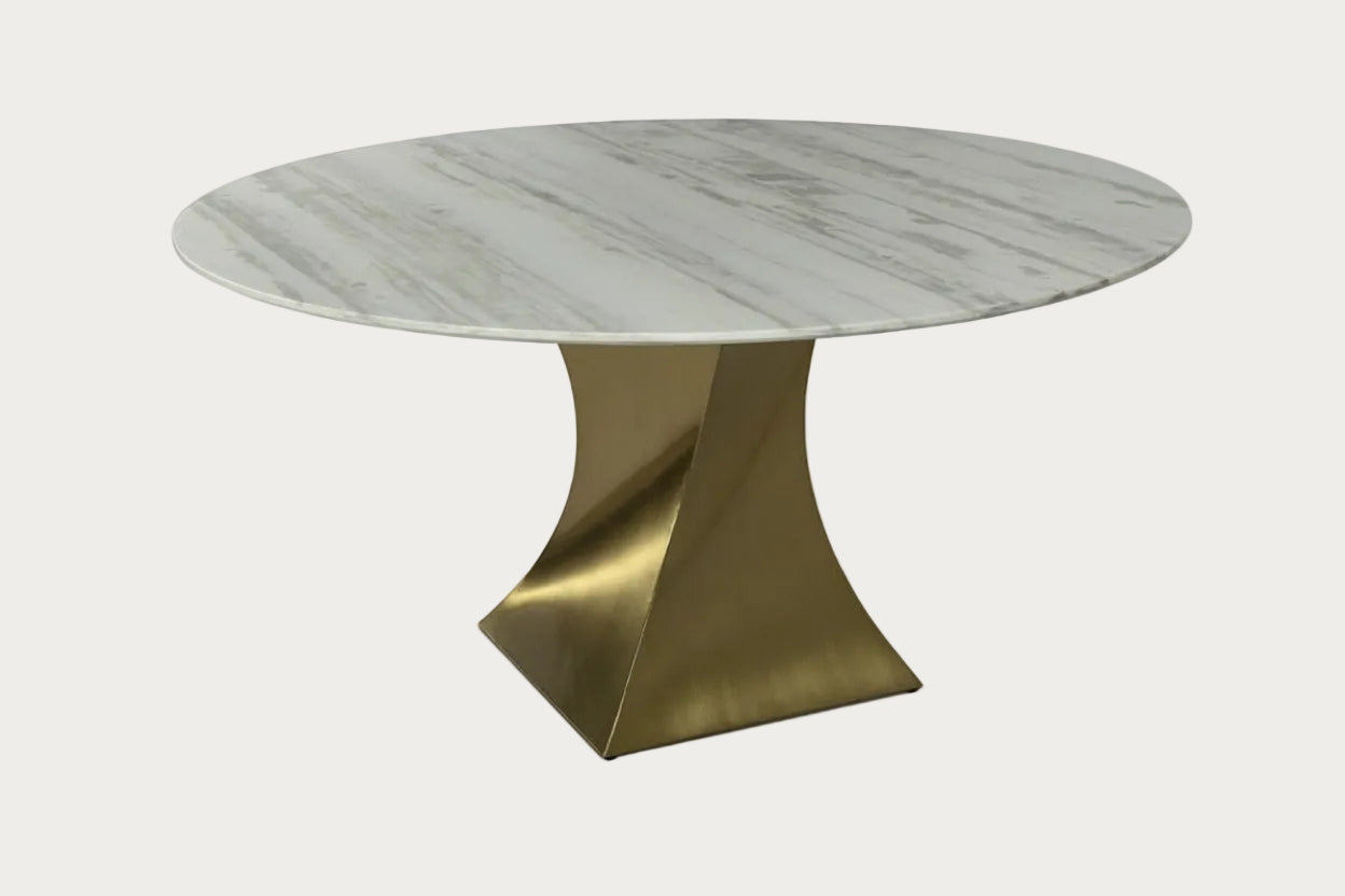 Twisted round marble table with a gold metal base on a white background