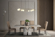 Zenith dining table with marble table and chairs under a modern chandelier.